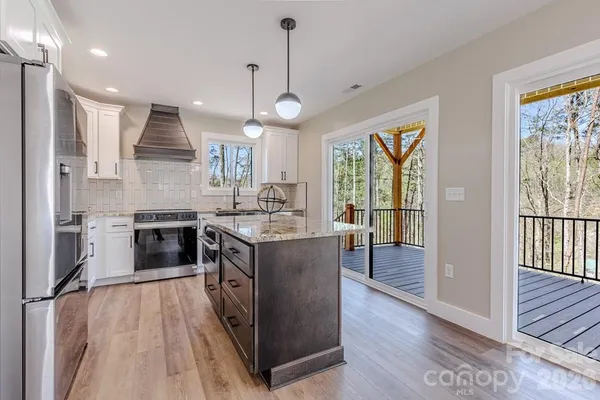 a kitchen with a stove kitchen island and stainless steel appliances