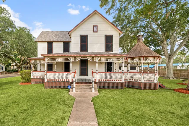 a front view of a house with a garden and deck