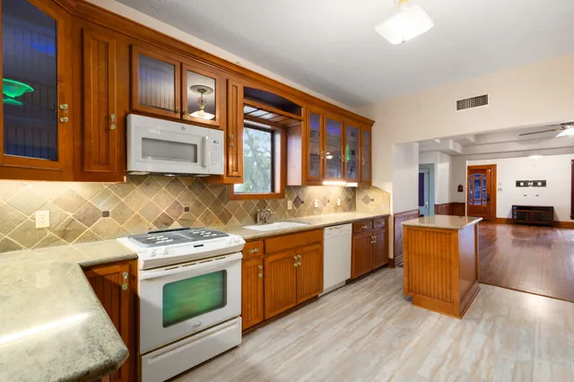 a kitchen with a stove a sink and a microwave