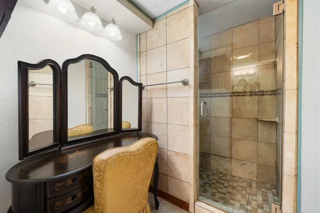 a view of a bathroom with mirror and window