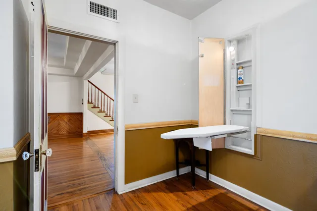 a view of a hallway with furniture and a window