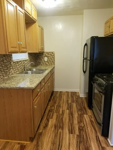 a kitchen with a sink stove and refrigerator