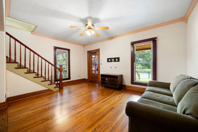 a living room with furniture and a wooden floor