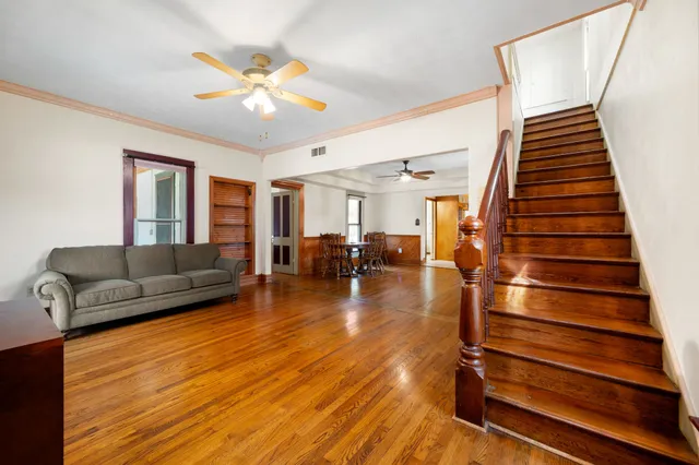 a living room with furniture and wooden floor