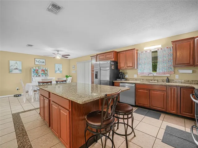 a kitchen with granite countertop sink cabinets and stainless steel appliances