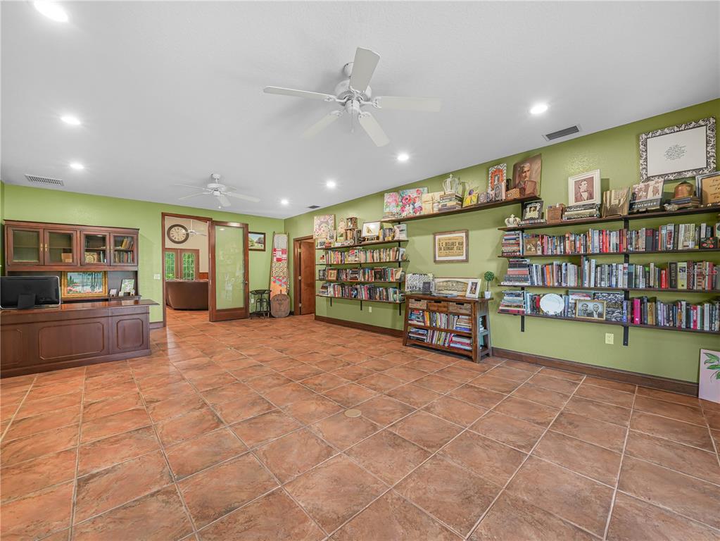 3963 Mammoth Grove Road Lake Wales, FL 33898 - Photo 16 of 42 a big room with lots of furniture and a book shelf