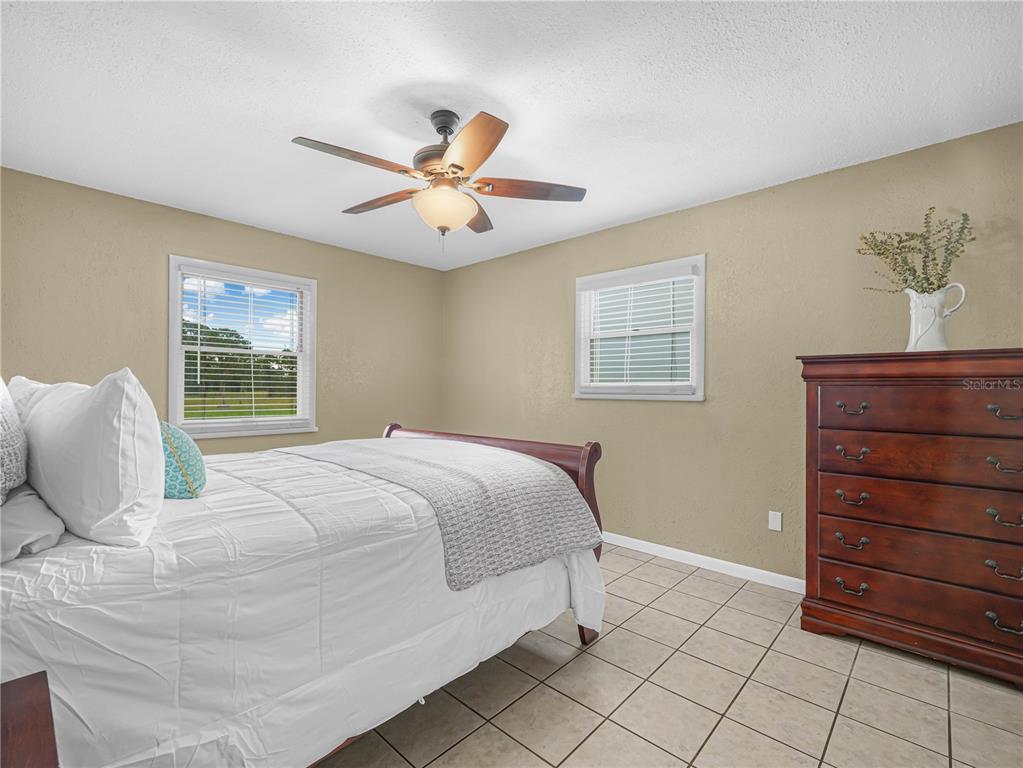 3963 Mammoth Grove Road Lake Wales, FL 33898 - Photo 22 of 42 a bedroom with a large bed and a window