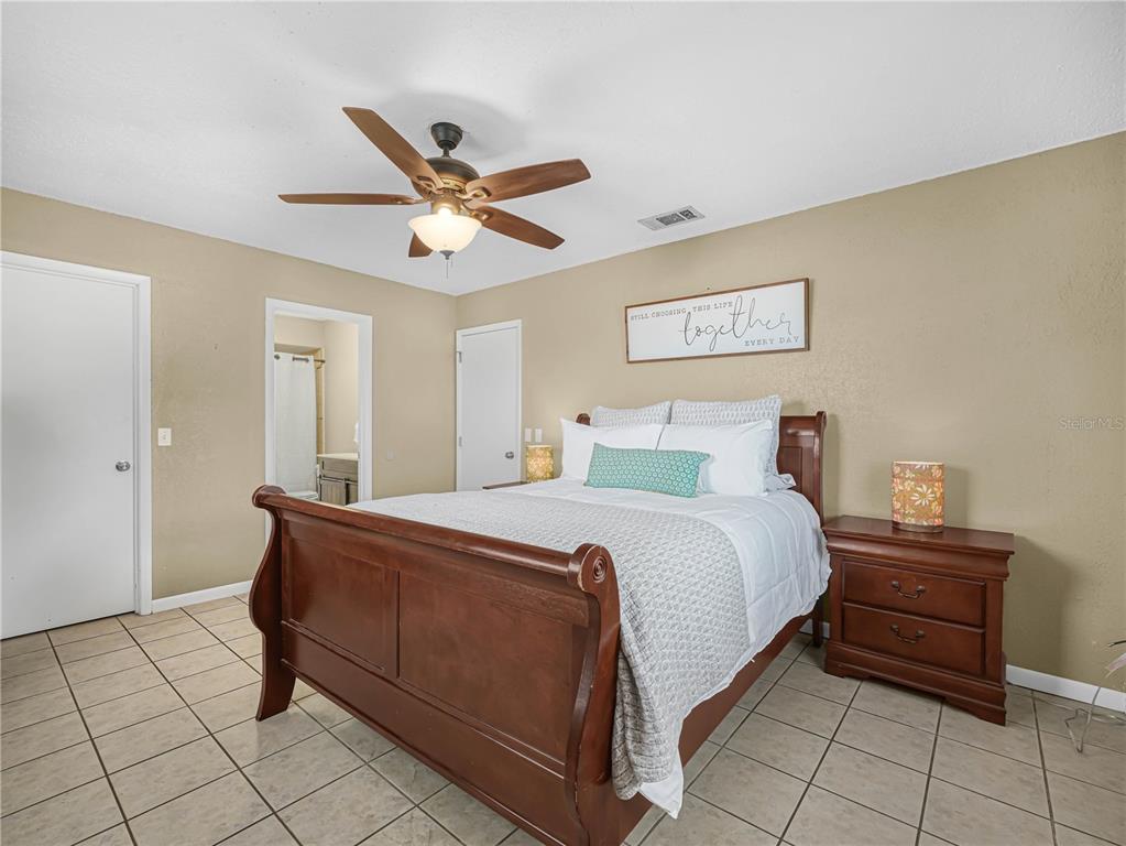 3963 Mammoth Grove Road Lake Wales, FL 33898 - Photo 23 of 42 a spacious bedroom with a bed and a table in it