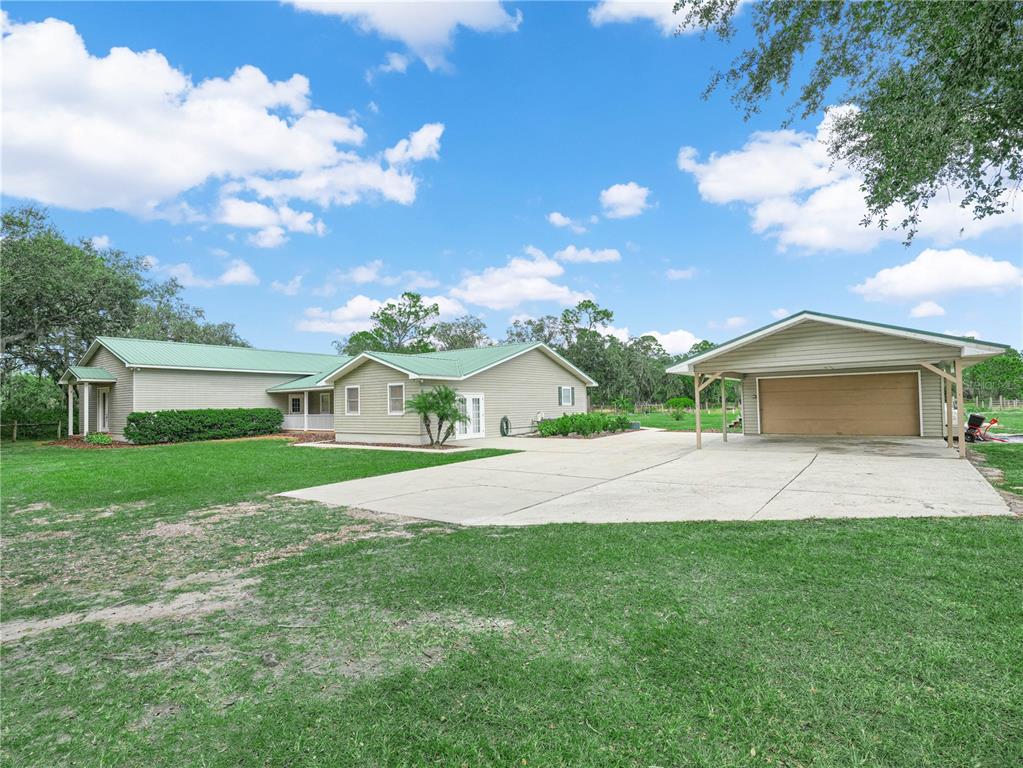 3963 Mammoth Grove Road Lake Wales, FL 33898 - Photo 4 of 42 a front view of a house with a yard and garage