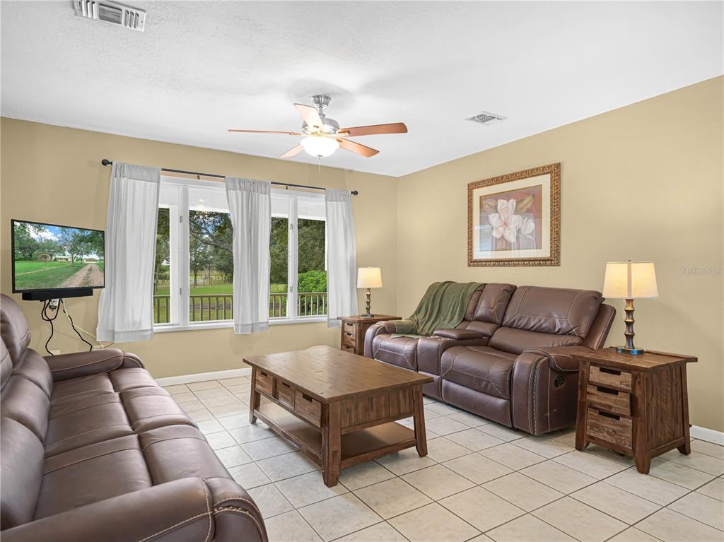 3963 Mammoth Grove Road Lake Wales, FL 33898 - Photo 9 of 42 a living room with furniture and a flat screen tv