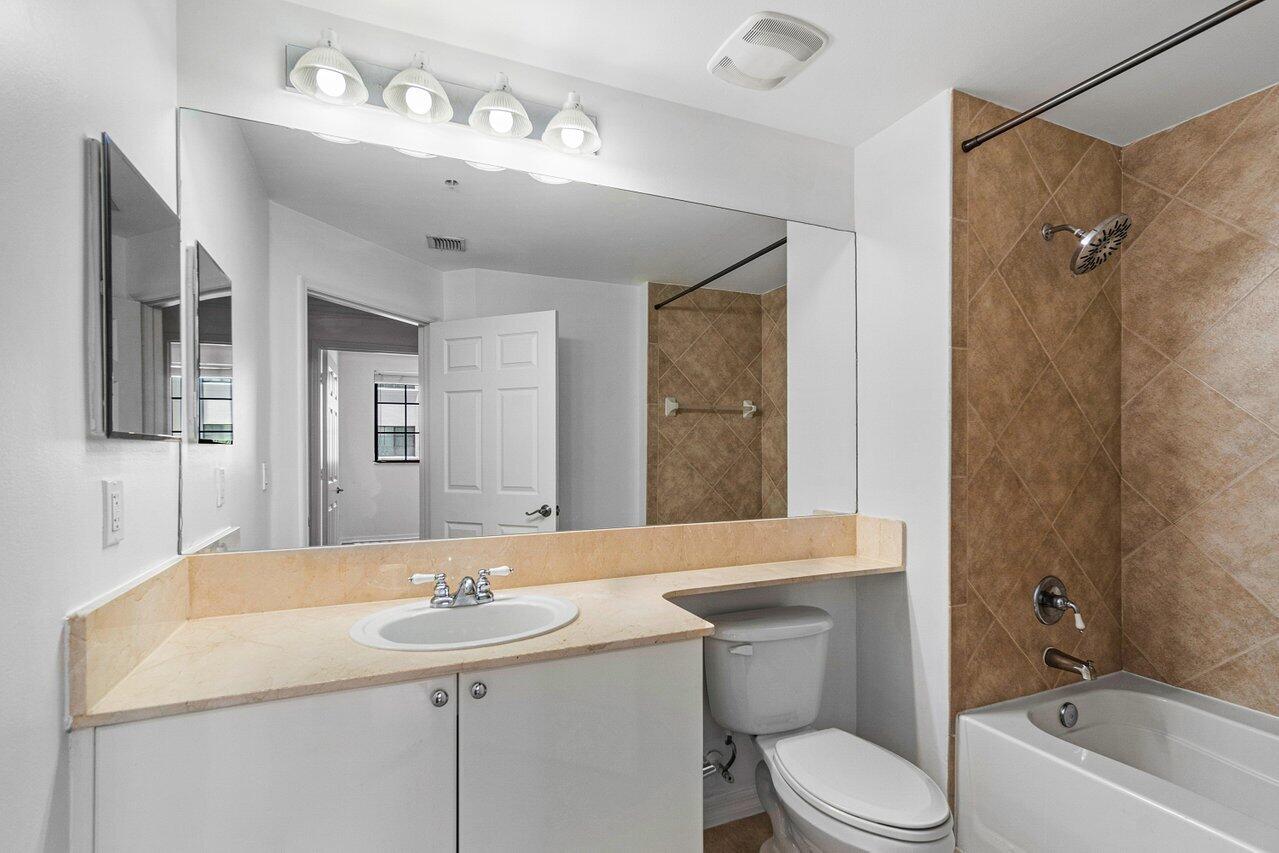 233 South Federal Highway, Unit 408 Boca Raton, FL 33432 - Photo 22 of 48 a bathroom with a sink a toilet and shower