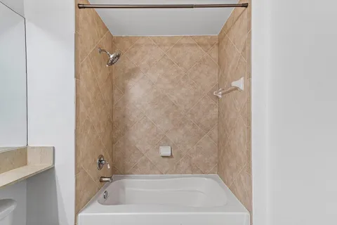 a bath tub sitting next to a white sink