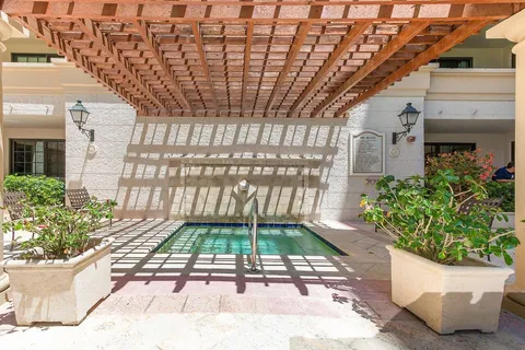 a view of front door with potted plants