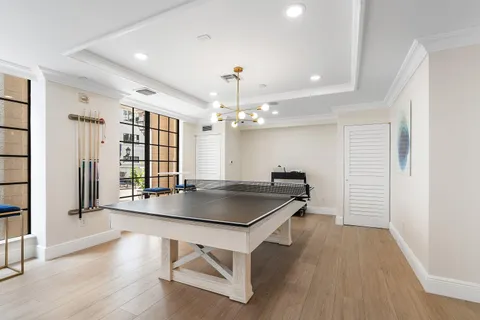 a room with table chairs and wooden floor