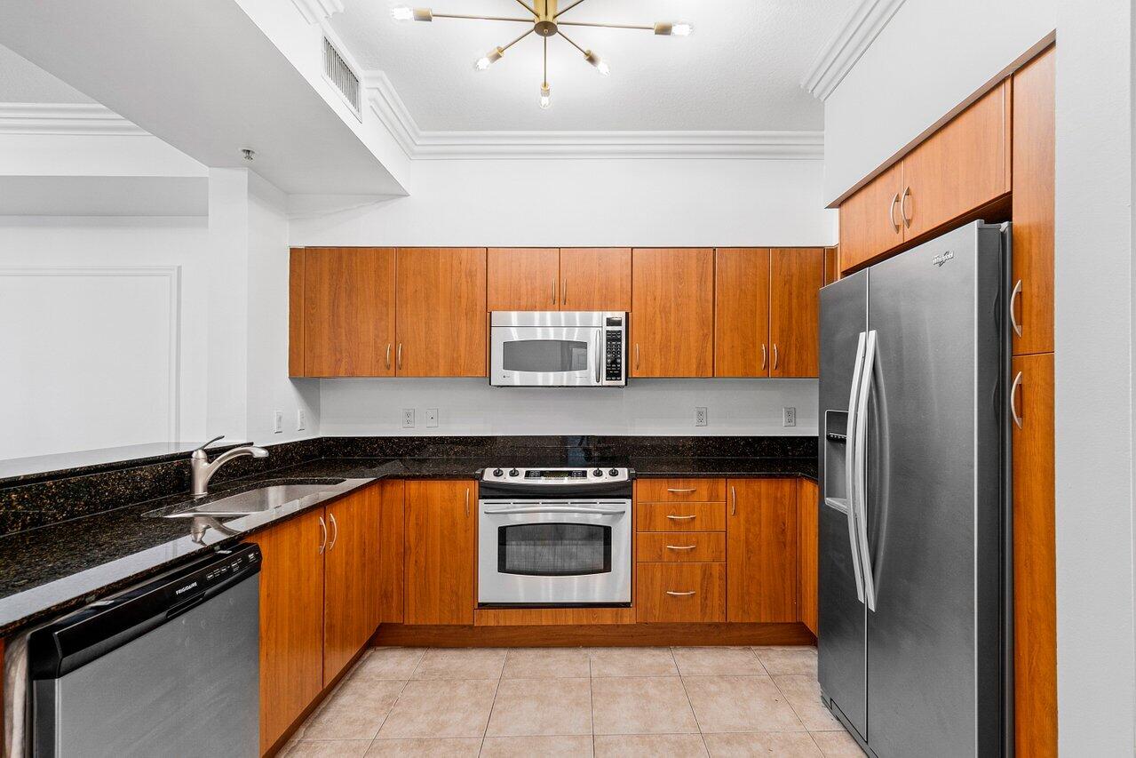 233 South Federal Highway, Unit 408 Boca Raton, FL 33432 - Photo 10 of 48 a kitchen with stainless steel appliances granite countertop a stove a refrigerator and a sink