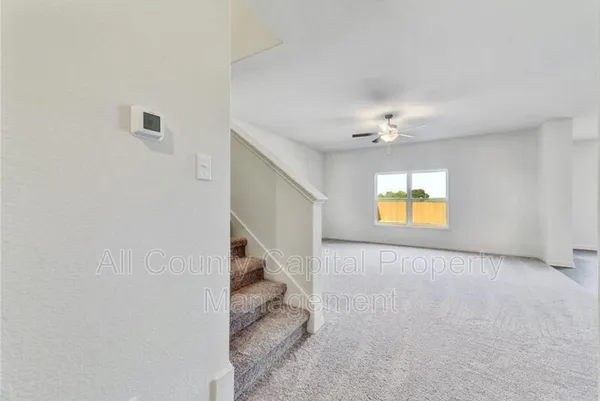 an empty room with a window and fireplace