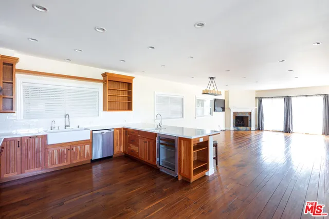 a kitchen with stainless steel appliances granite countertop a sink stove and wooden floor