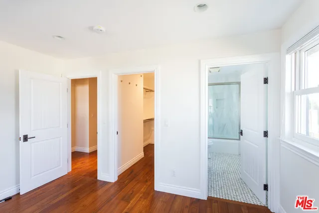 a bathroom with a sink a mirror and a shower