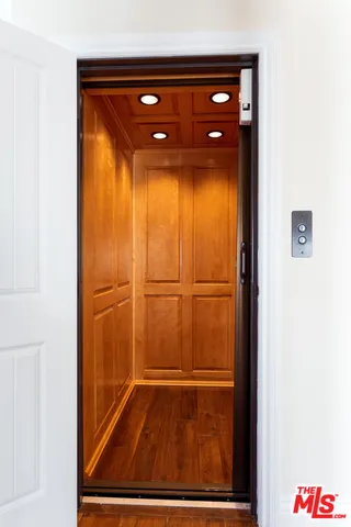 a view of walk in closet with wooden floor