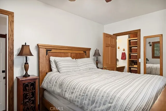 a bedroom with a bed and a mirror