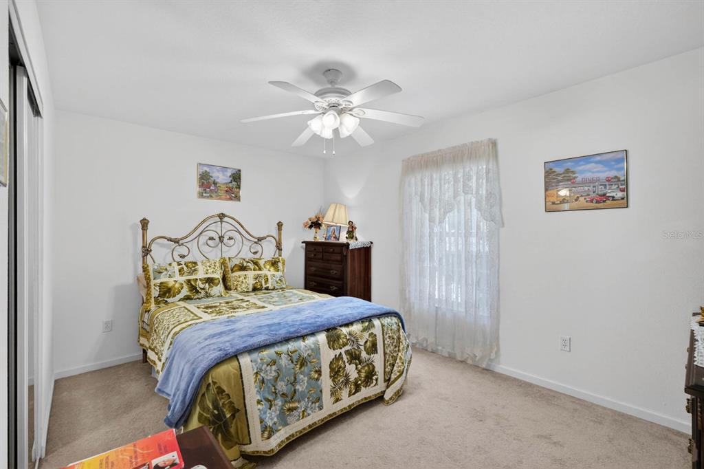 80 Roxboro Drive Palm Coast, FL 32164 - Photo 17 of 39 a bedroom with a bed and a chandelier