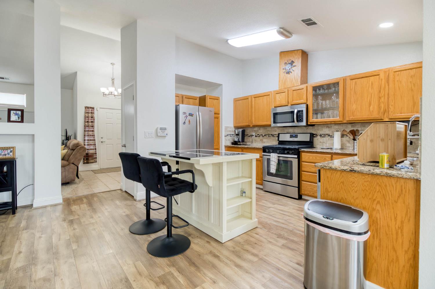 2913 Soquel Avenue Atwater, CA 95301 - Photo 11 of 29 a kitchen with stainless steel appliances a stove a sink dishwasher and a refrigerator