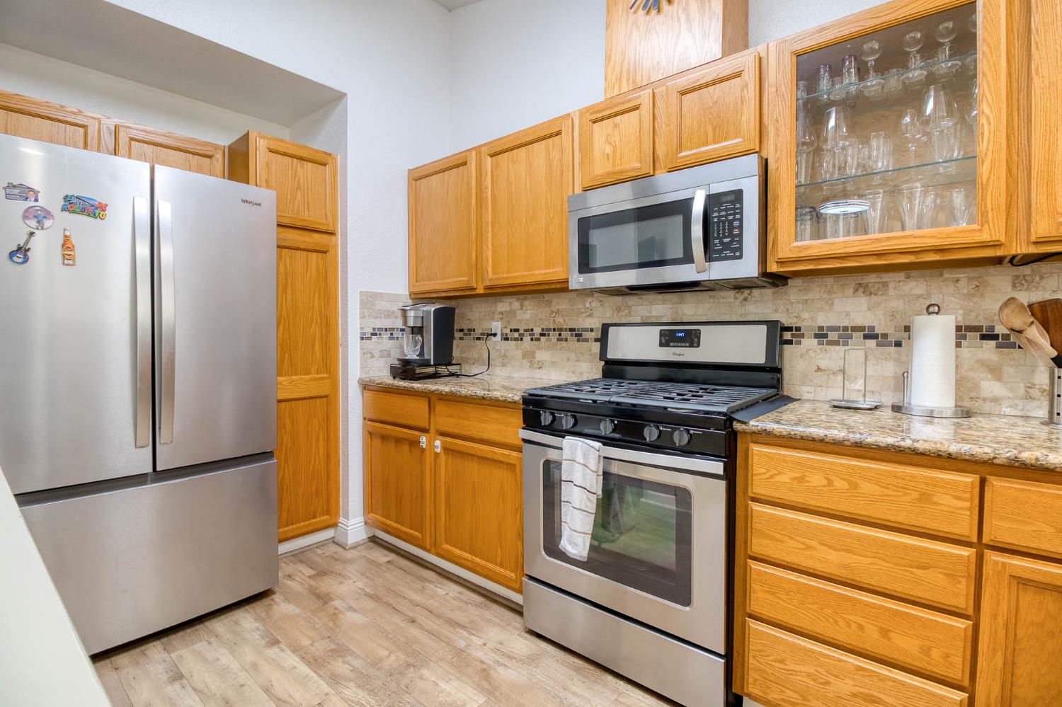 2913 Soquel Avenue Atwater, CA 95301 - Photo 13 of 29 a kitchen with stainless steel appliances a stove a microwave and a refrigerator