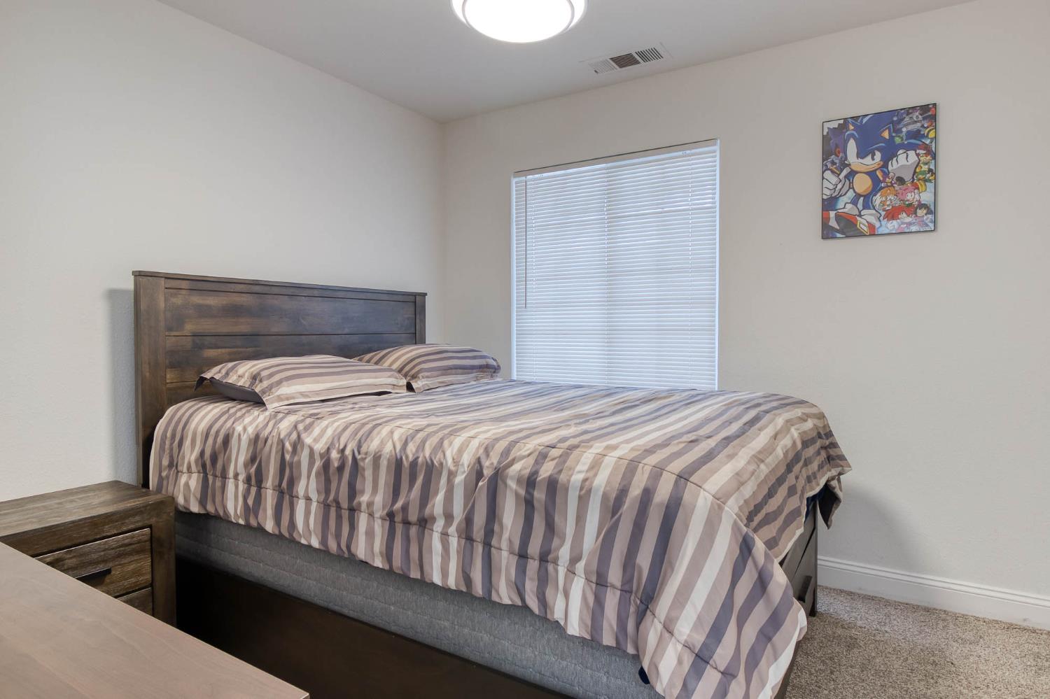 2913 Soquel Avenue Atwater, CA 95301 - Photo 18 of 29 a bedroom with a bed and painting on the wall