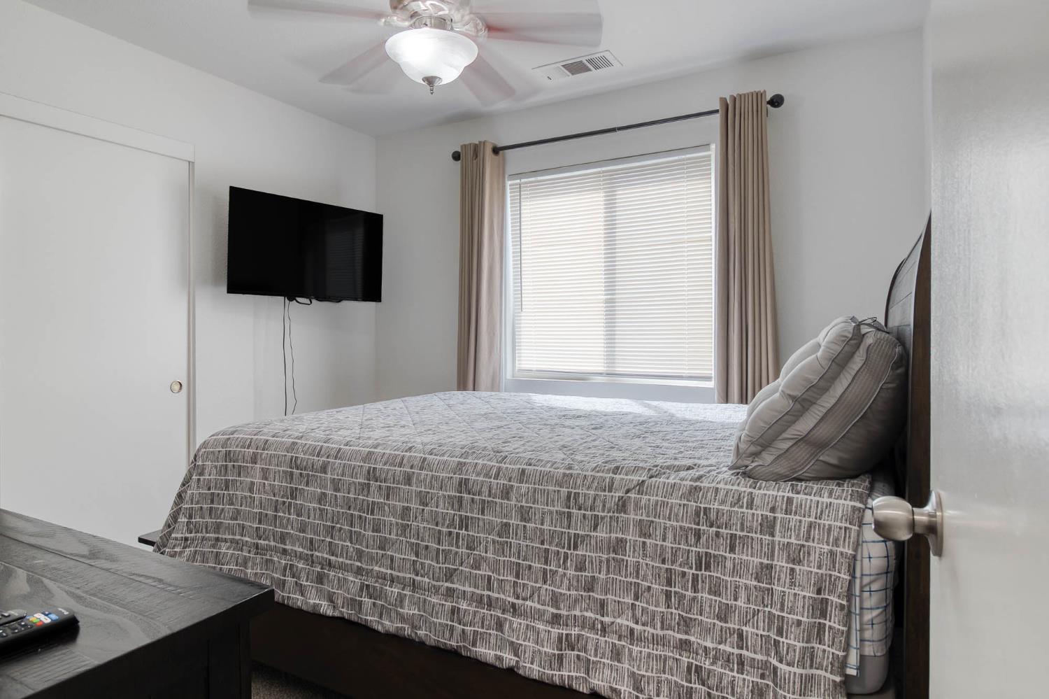 2913 Soquel Avenue Atwater, CA 95301 - Photo 19 of 29 a bedroom with a bed and a flat screen tv