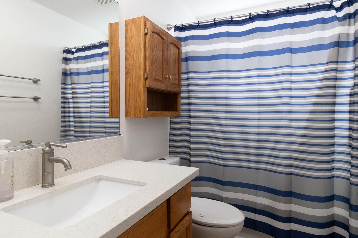 2913 Soquel Avenue Atwater, CA 95301 - Photo 20 of 29 a bathroom with a sink a toilet and shower