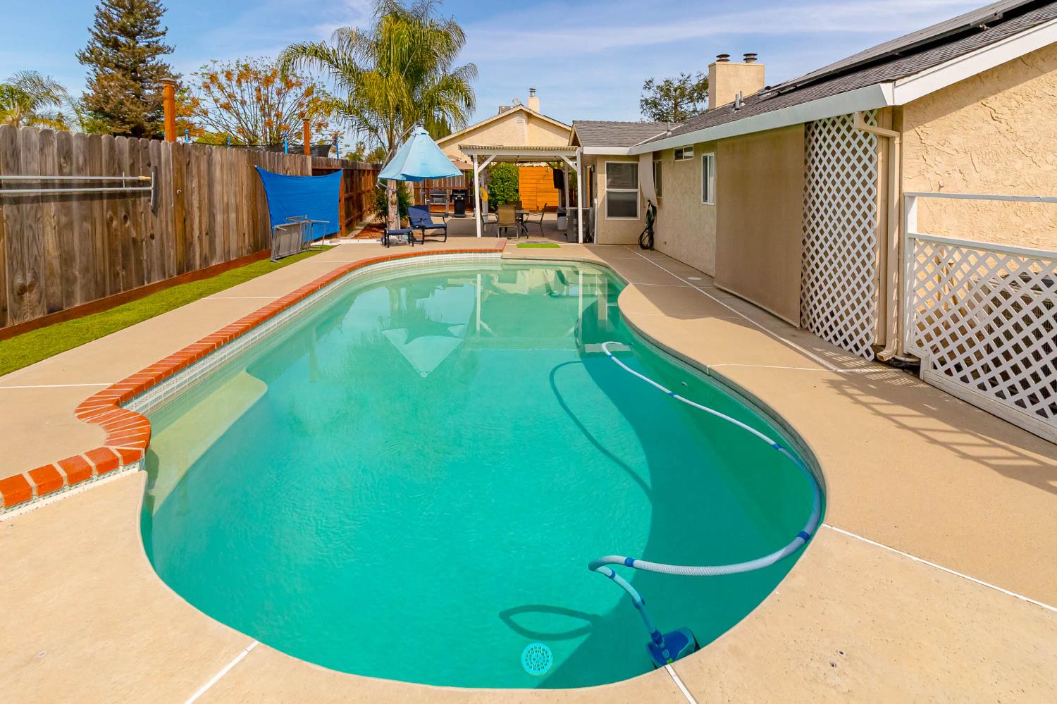 2913 Soquel Avenue Atwater, CA 95301 - Photo 28 of 29 a view of a swimming pool with a chairs