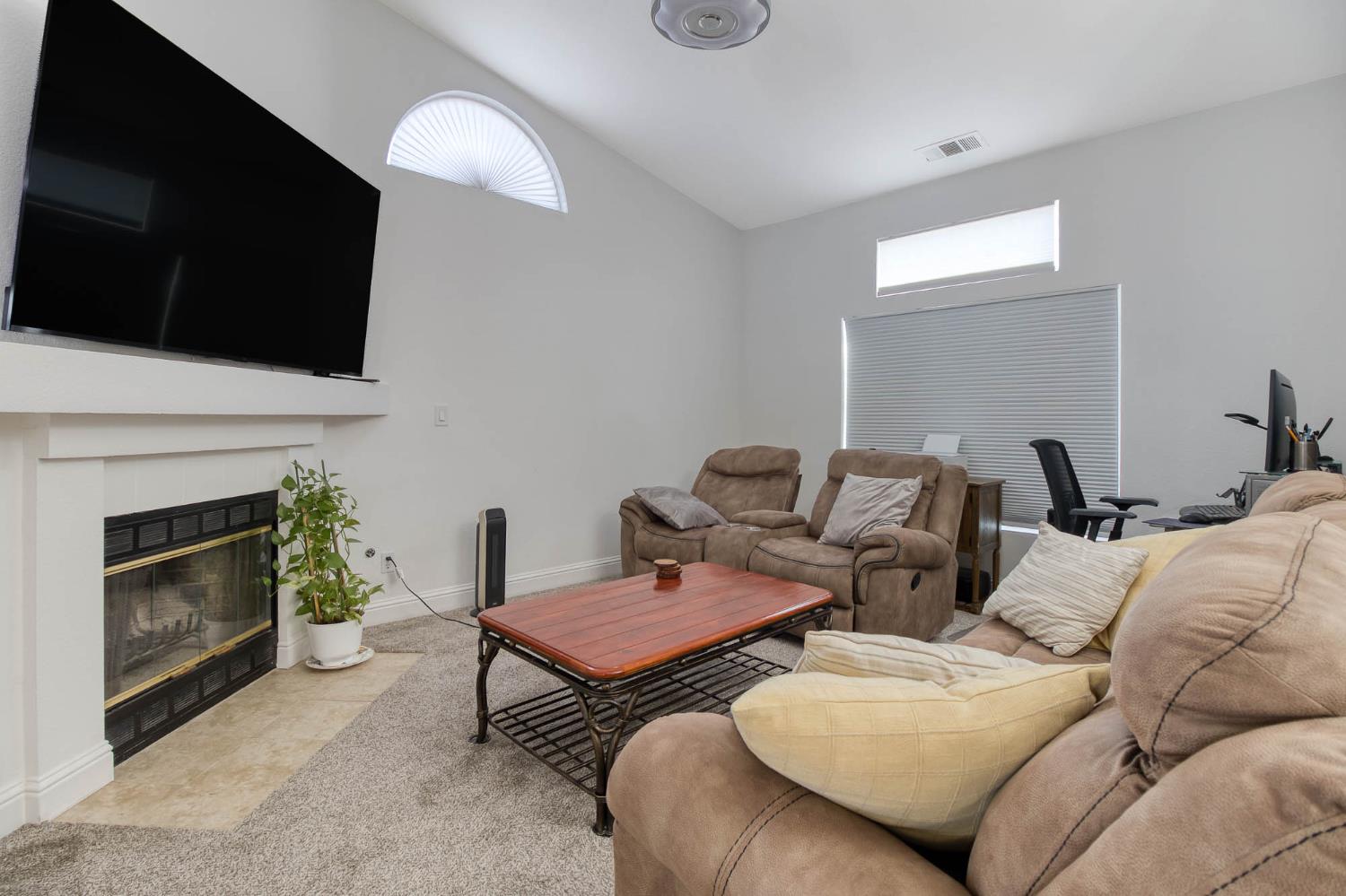 2913 Soquel Avenue Atwater, CA 95301 - Photo 7 of 29 a living room with furniture a flat screen tv and a fireplace
