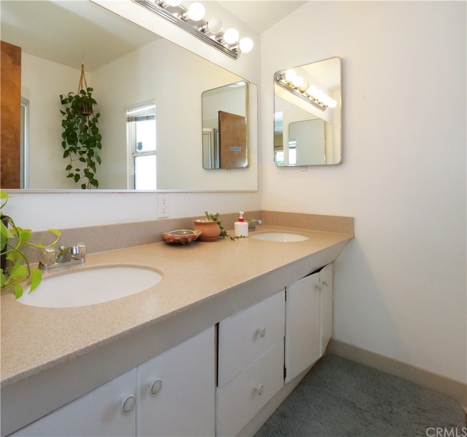 5063 Foxpoint Lane Rolling Hills Estates, CA 90274 - Photo 23 of 35 a bathroom with a granite countertop sink and a mirror