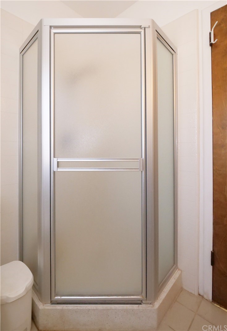 5063 Foxpoint Lane Rolling Hills Estates, CA 90274 - Photo 24 of 35 a bathroom with a glass shower door