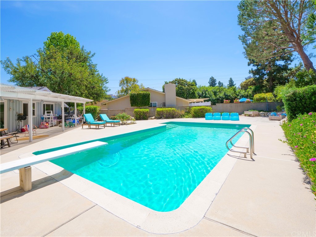 5063 Foxpoint Lane Rolling Hills Estates, CA 90274 - Photo 33 of 35 a view of a swimming pool with lawn chairs and plants