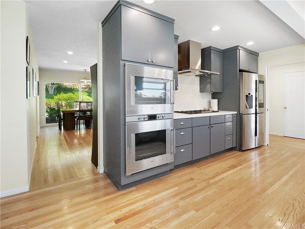 5063 Foxpoint Lane Rolling Hills Estates, CA 90274 - Photo 9 of 35 a open kitchen with stainless steel appliances granite countertop a stove a refrigerator and a view of living room