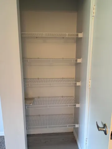 a refrigerator with white wooden cabinets