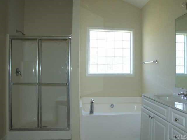 3915 Cane Garden Drive Raleigh, NC 27610 - Photo 7 of 8 a bathroom with a bathtub and a shower