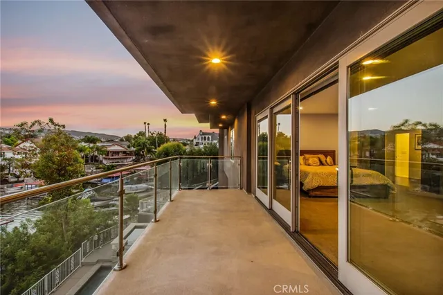 a view of a lake with couches in the patio