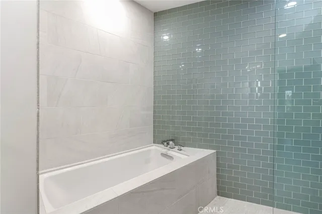 a view of a patio with table and chairs under an umbrella