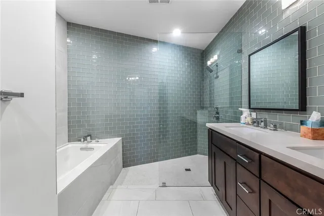 an aerial view of a house with a garden and lake view