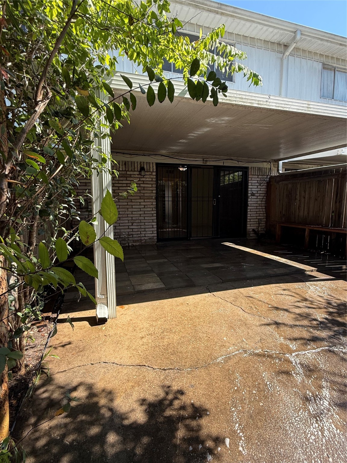 8140 Fondren Road, Unit 8140 Houston, TX 77074 - Photo 13 of 28 two-story townhouse with a mix of brick and siding exterior. It features a small front yard with a concrete path leading to the entrance. Large windows on the second floor and a neatly landscaped area enhance its curb appeal.