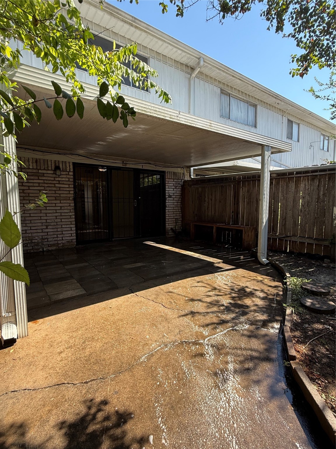 8140 Fondren Road, Unit 8140 Houston, TX 77074 - Photo 14 of 28 two-story townhouse with a mix of brick and siding exterior. It features a small front yard with a concrete path leading to the entrance. Large windows on the second floor and a neatly landscaped area enhance its curb appeal.