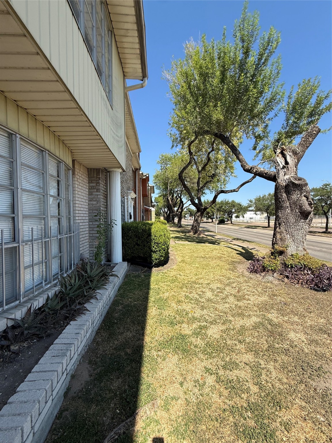 8140 Fondren Road, Unit 8140 Houston, TX 77074 - Photo 28 of 28 Charming home exterior with a well-maintained lawn and mature trees lining the street. Brick and siding facade offers a classic look, complemented by large windows and tidy landscaping. Quiet, tree-lined neighborhood.