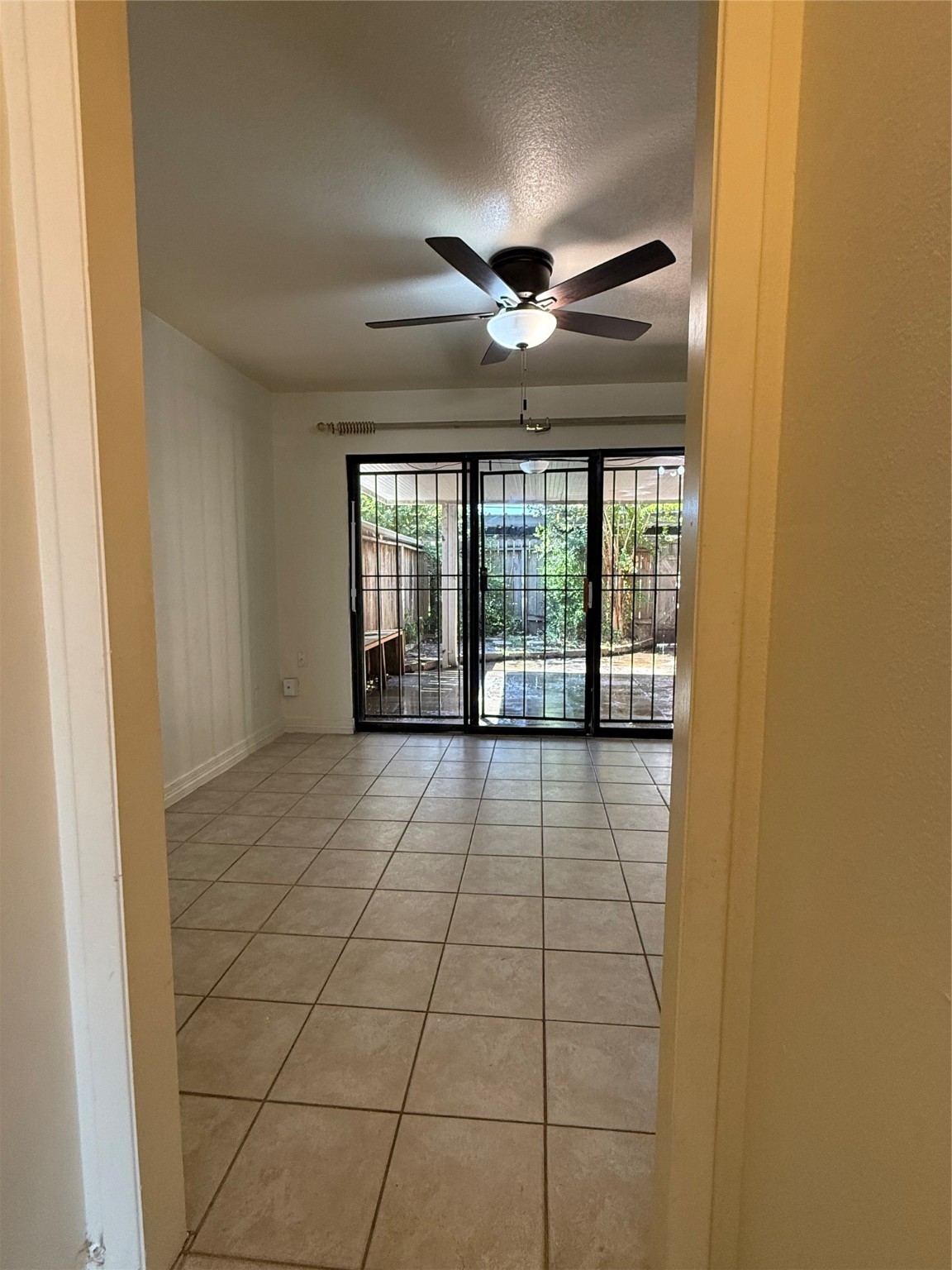 8140 Fondren Road, Unit 8140 Houston, TX 77074 - Photo 6 of 28 two-story townhouse with a mix of brick and siding exterior. It features a small front yard with a concrete path leading to the entrance. Large windows on the second floor and a neatly landscaped area enhance its curb appeal.