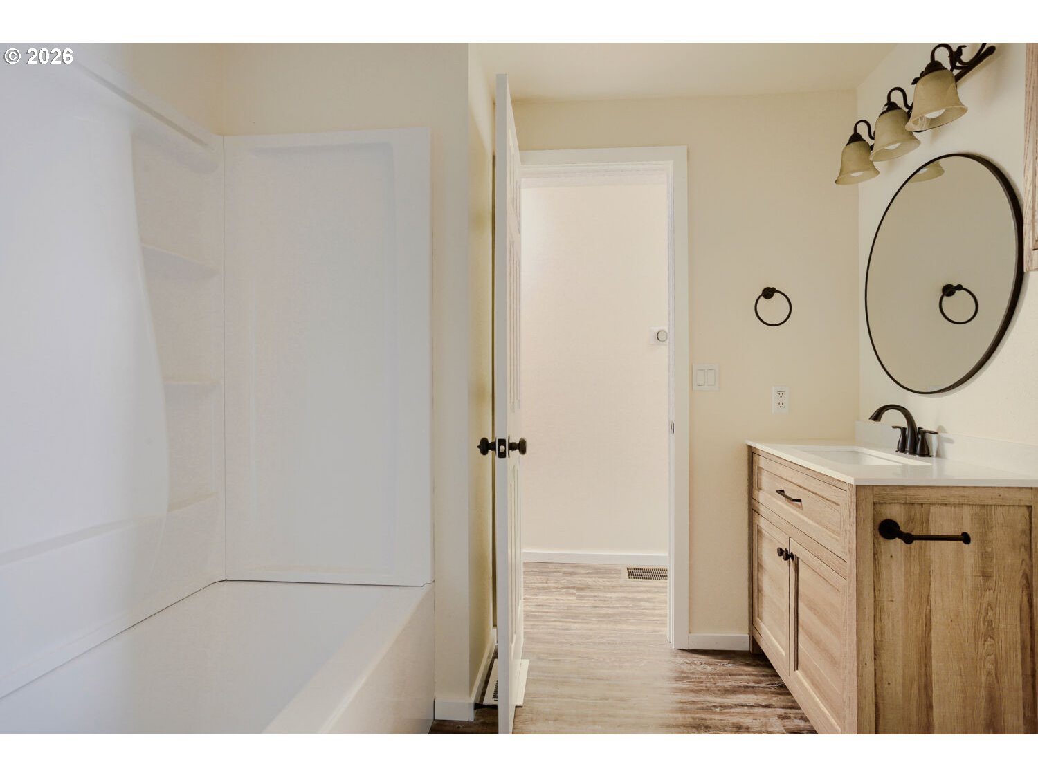 14539 Southeast Center Street Portland, OR 97236 - Photo 15 of 30 a view of a bathroom with a sink mirror and shower
