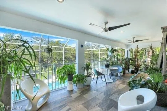 a view of a porch with chairs and potted plants