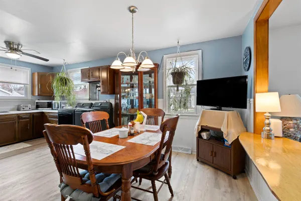 a living room with furniture a flat screen tv and a window