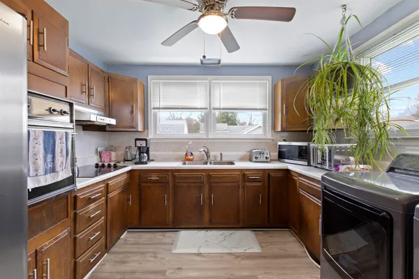 a living room with furniture a window and a chandelier