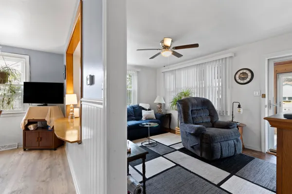 a view of a house with a big yard and large trees